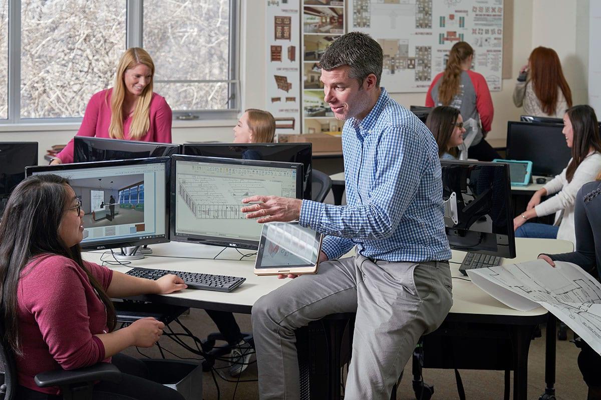 Interior Design professor Mike Kelly discussing a project with a student in class